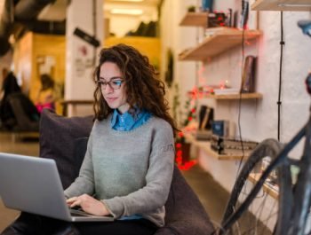 Young entrepreneur female is preparing a presentation on a laptop.