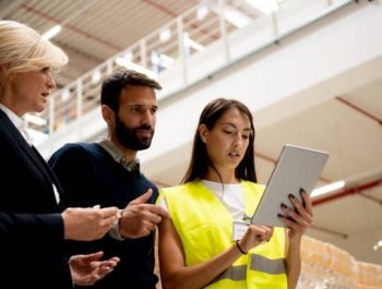 Managers checking the list of products in warehouse